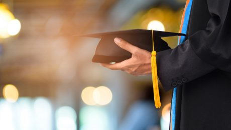 Graduation take a black yellow tassel in front of bokeh blurry b